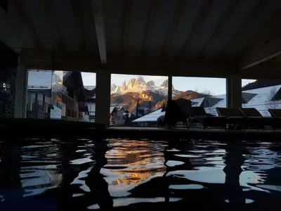 a swimming pool with a view of a mountain at Residence Cirelle Suite & Spa in Canazei