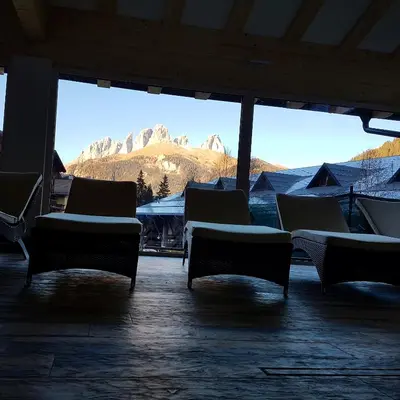 a room with chairs and a view of a mountain at Residence Cirelle Suite & Spa in Canazei