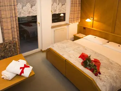 a hotel room with two beds with christmas decorations at Residence Cirelle Suite & Spa in Canazei