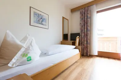 a hotel room with a bed and a window at LINGHOF in Tirolo