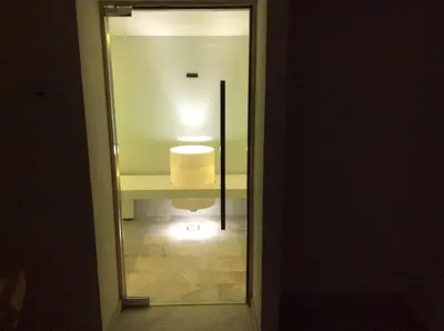 a mirror in a hallway with a light in a room at Hotel Silvana in Selva di Val Gardena