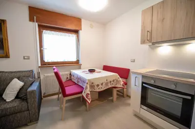 a small living room with a table and a couch at Apartments Cesa Bruma in Ortisei