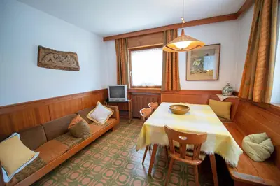 a living room with a couch and a table at Apartments Cesa Bruma in Ortisei