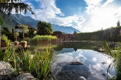 a body of water with mountains in the background at Hotel Rössl in Rablà