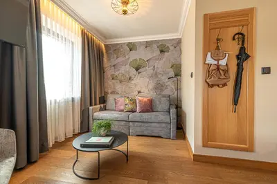 a living room with a couch and a table at Hotel Zum Mohren in Tesimo