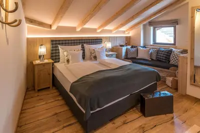 a bedroom with a large bed and a couch at Hotel Zum Mohren in Tesimo