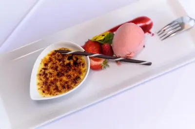 a plate of food with ice cream and strawberries at Hotel Zum Mohren in Tesimo