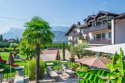 a house with a playground in front of it at Hotel Christine in Gargazzone