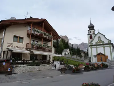 a restaurant with two tables and a counter at Chalet Ciasa Alexander in San Cassiano