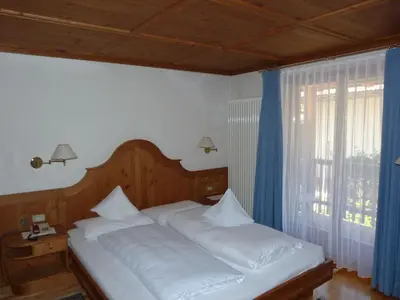 a dining room with tables with white tablecloths at Chalet Ciasa Alexander in San Cassiano