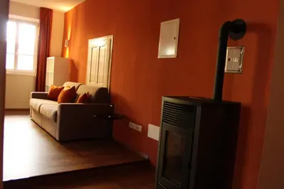a living room with a couch and a television at The Court House in Bressanone