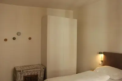 a bedroom with a bed and a white cabinet at The Court House in Bressanone