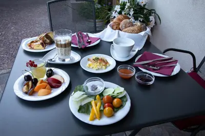 a black table with plates of food on it at Rebenheim in Termeno