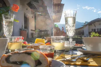 a table with food and glasses on a table at Rebenheim in Termeno