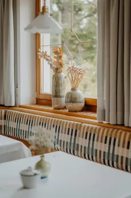 a window with two vases on a window sill at Waidmannhof in Merano