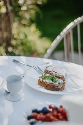 a plate with a piece of food on a table at Waidmannhof in Merano