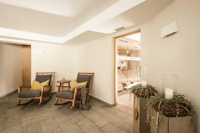 a waiting room with two chairs and a table at Hotel Mitterplatt (Schenna Resort) in Schenna