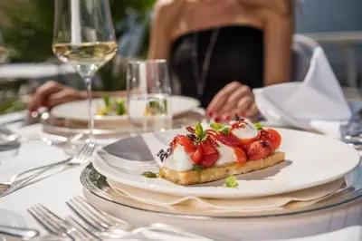 a table with a plate of food on a table at Hotel Mitterplatt (Schenna Resort) in Schenna