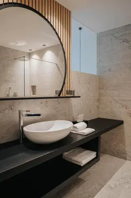a bathroom with a large bowl sink on a counter at Small Hotel Sonne in Tirolo