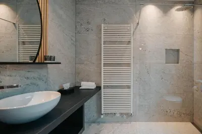 a bathroom with a sink and a shower at Small Hotel Sonne in Tirolo