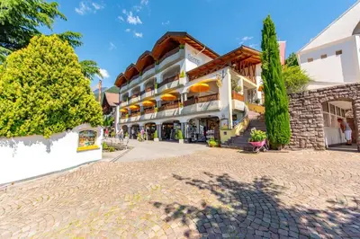 a cobblestone street in front of a building at Small Hotel Sonne in Tirolo