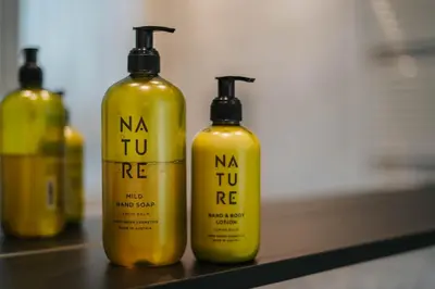 a group of three yellow bottles sitting on a counter at Small Hotel Sonne in Tirolo