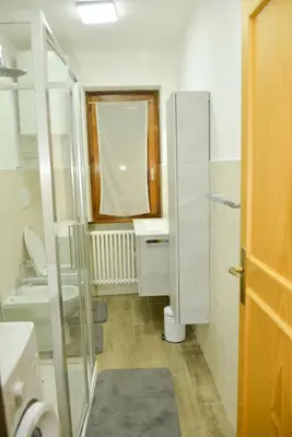 a small bathroom with a sink and a toilet at CASA GILDA Val di Fiemme - Dolomiti in Cavalese