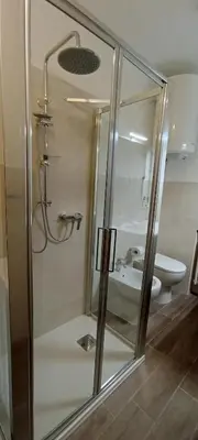 a bathroom with a shower with a sink and a toilet at CASA GILDA Val di Fiemme - Dolomiti in Cavalese