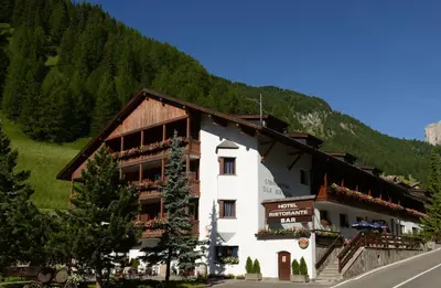 a building on the side of a mountain at Hotel Casa Alpina - Alpin Haus in Selva di Val Gardena