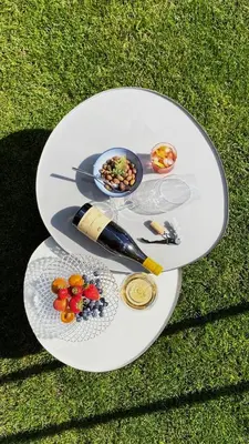 a white table with food on top of the grass at Apartmenthotel Ritterhof Suites & Breakfast in Schenna