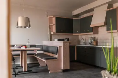 a kitchen with a table and a table and a table at Apartmenthotel Ritterhof Suites & Breakfast in Schenna