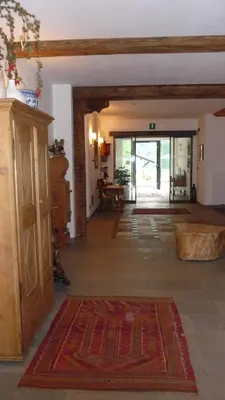 a living room with a large rug on the floor at Residence Prapoz in Ortisei