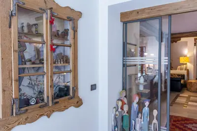 a room with a glass cabinet with figurines in it at Residence Prapoz in Ortisei