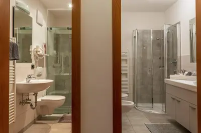 a kitchen with white cabinets and a sink at Residence Prapoz in Ortisei