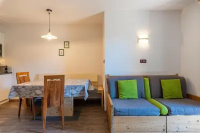 a kitchen and dining room with a table in a room at Residence Prapoz in Ortisei