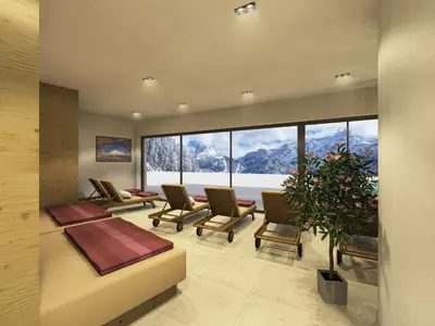 a living room with chairs and a large window at Hotel Rodella in Selva di Val Gardena