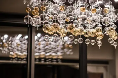 a chandelier in front of a window at Hotel Rodella in Selva di Val Gardena