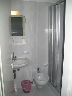 a bathroom with a sink and a toilet and a shower at Verda Val in Campitello di Fassa