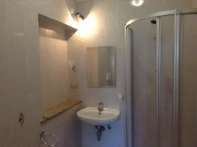 a bathroom with a sink and a shower at Verda Val in Campitello di Fassa