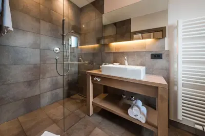 a bathroom with a sink and a shower at Boutiquehotel Minigolf in Tirolo