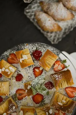 a plate of desserts on a table with pastries at Boutiquehotel Minigolf in Tirolo
