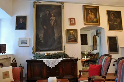 a living room with a large painting on the wall at Hotel Ansitz Kandelburg in Mühlbach