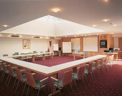 a large conference room with a long table and chairs at Hotel Ansitz Kandelburg in Mühlbach
