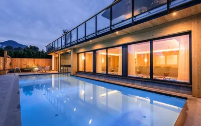 a swimming pool in front of a house at Hotel Jonathan in Naz-Sciaves