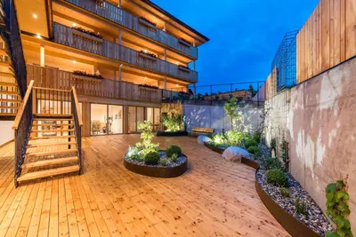 a courtyard of a building with stairs and plants at Hotel Jonathan in Naz-Sciaves
