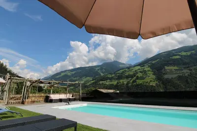 a living room with a counter and a kitchen at Bognerhof in Rifiano