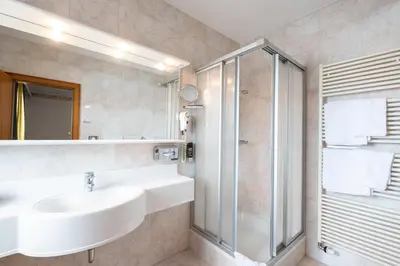 a bathroom with a sink and a shower at Hotel Reipertingerhof in Brunico