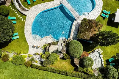 an aerial view of a swimming pool in a yard at Hotel Olympia in Brunico