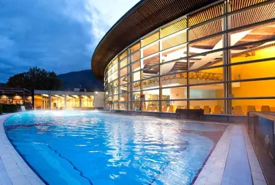 a large building with a swimming pool in front of it at WEINBERG APARTMENTS with Brixen Südtirol Card in Naz-Sciaves