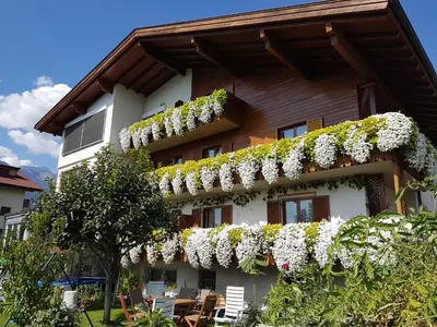 a building with flowers on the side of it at WEINBERG APARTMENTS with Brixen Südtirol Card in Naz-Sciaves